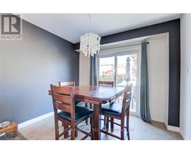 A dining room with a wooden table and chairs.