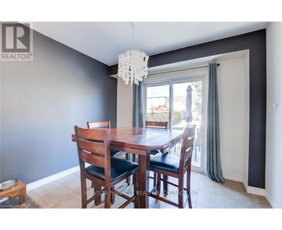 A dining room with a wooden table and chairs.