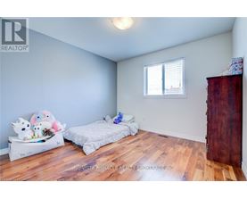 A bedroom with a bed and a bench with stuffed animals on it.