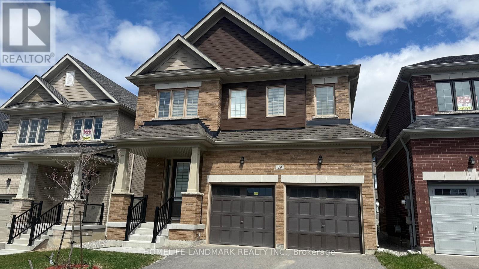 A row of houses with garages and driveways.