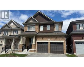 A row of houses with garages and driveways.
