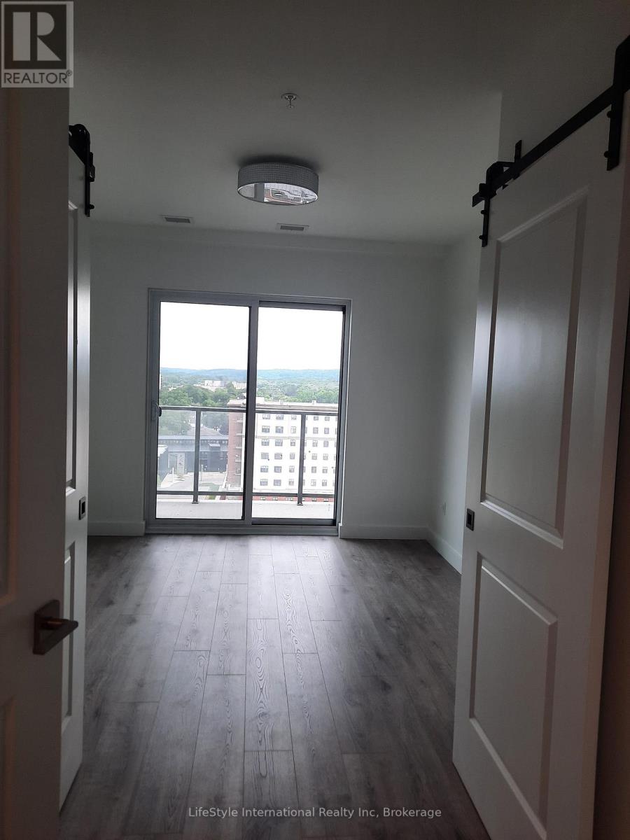 A room with a view of the city through large windows.