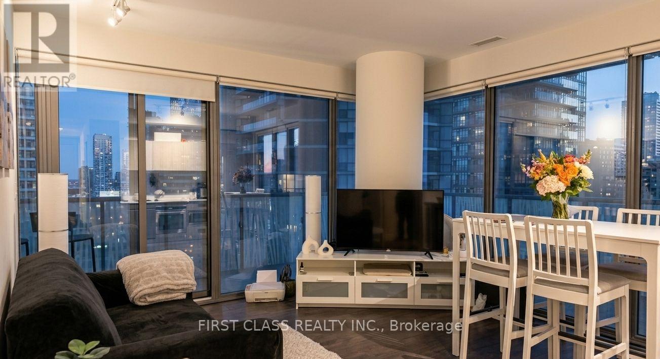 A living room with a couch, chair, and television.