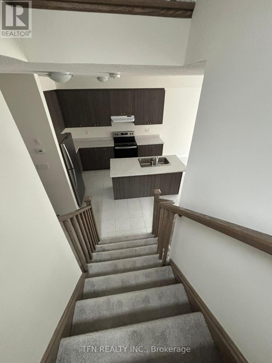 A staircase leads to a kitchen area.