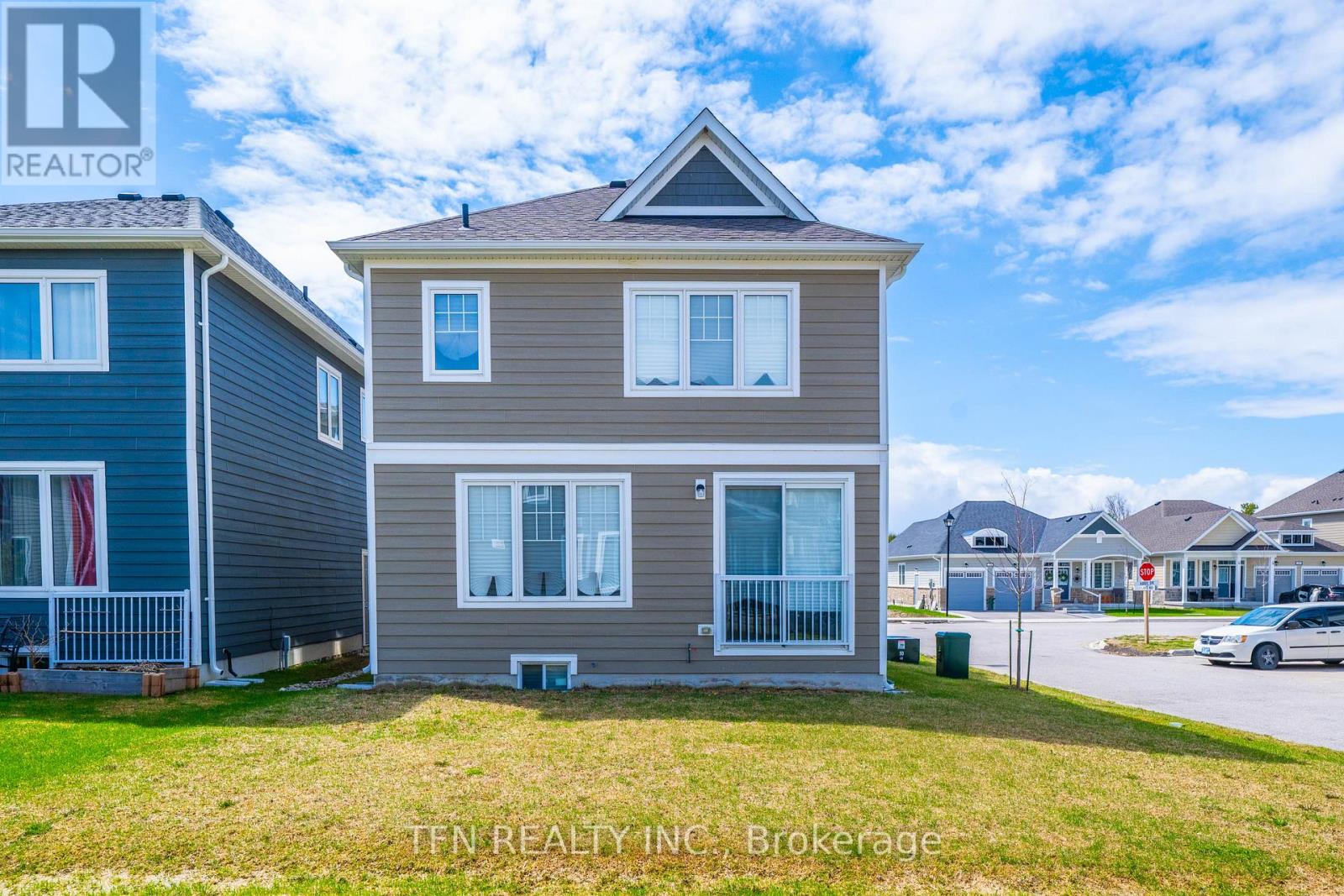 A house with a blue and grey exterior is for sale.