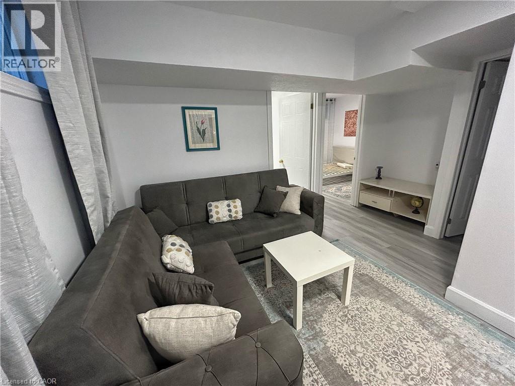 A living room with a grey couch and a white coffee table.