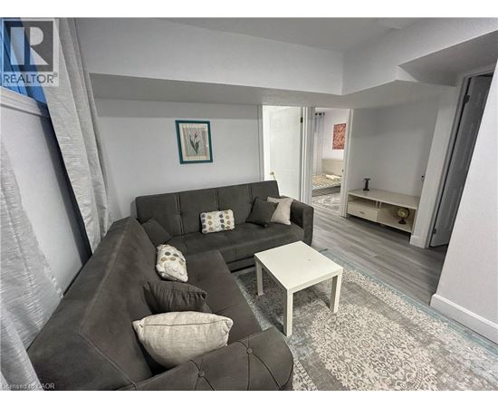 A living room with a grey couch and a white coffee table.