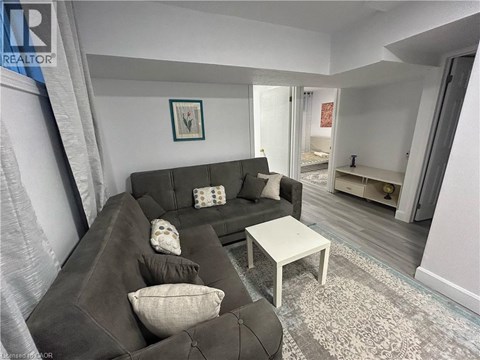 A living room with a grey couch and a white coffee table.