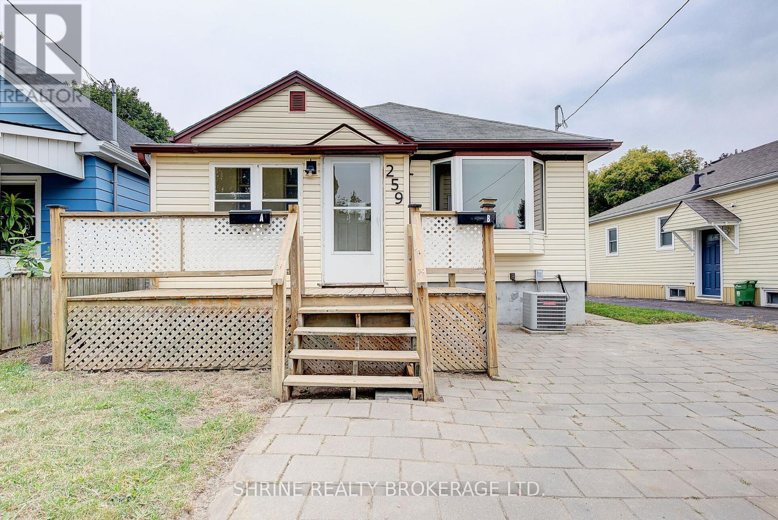 A house with a porch and a wooden fence.