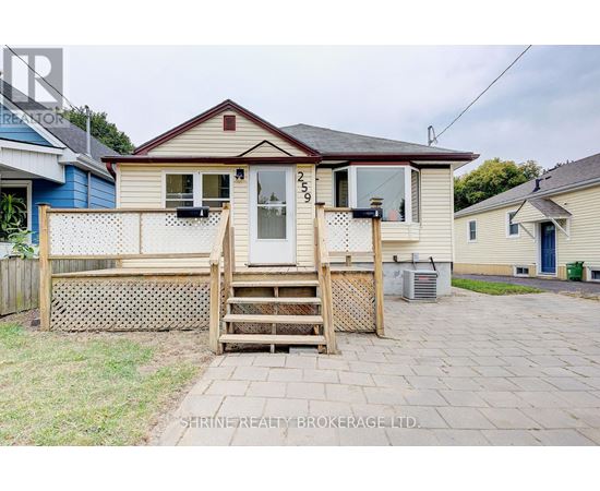 A house with a porch and a wooden fence.