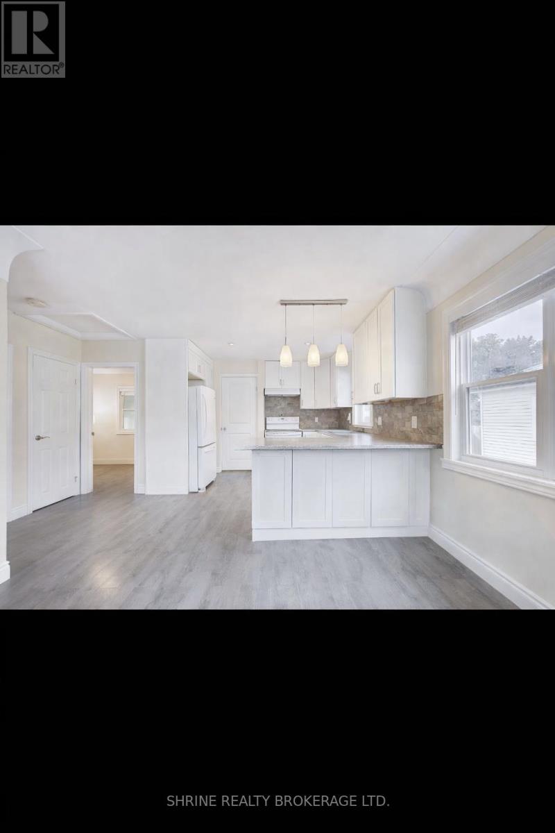 A well-lit, spacious kitchen with white cabinetry and a large island.