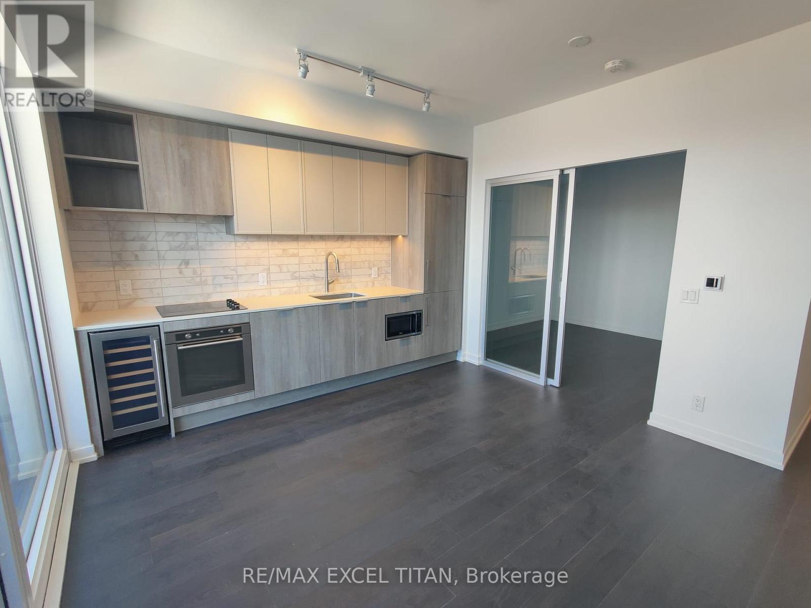 A modern kitchen with RE/MAX EXCEL TITAN, Brokerage logo.