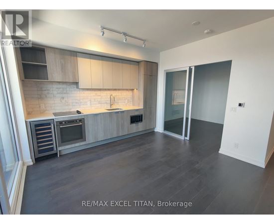 A modern kitchen with RE/MAX EXCEL TITAN, Brokerage logo.
