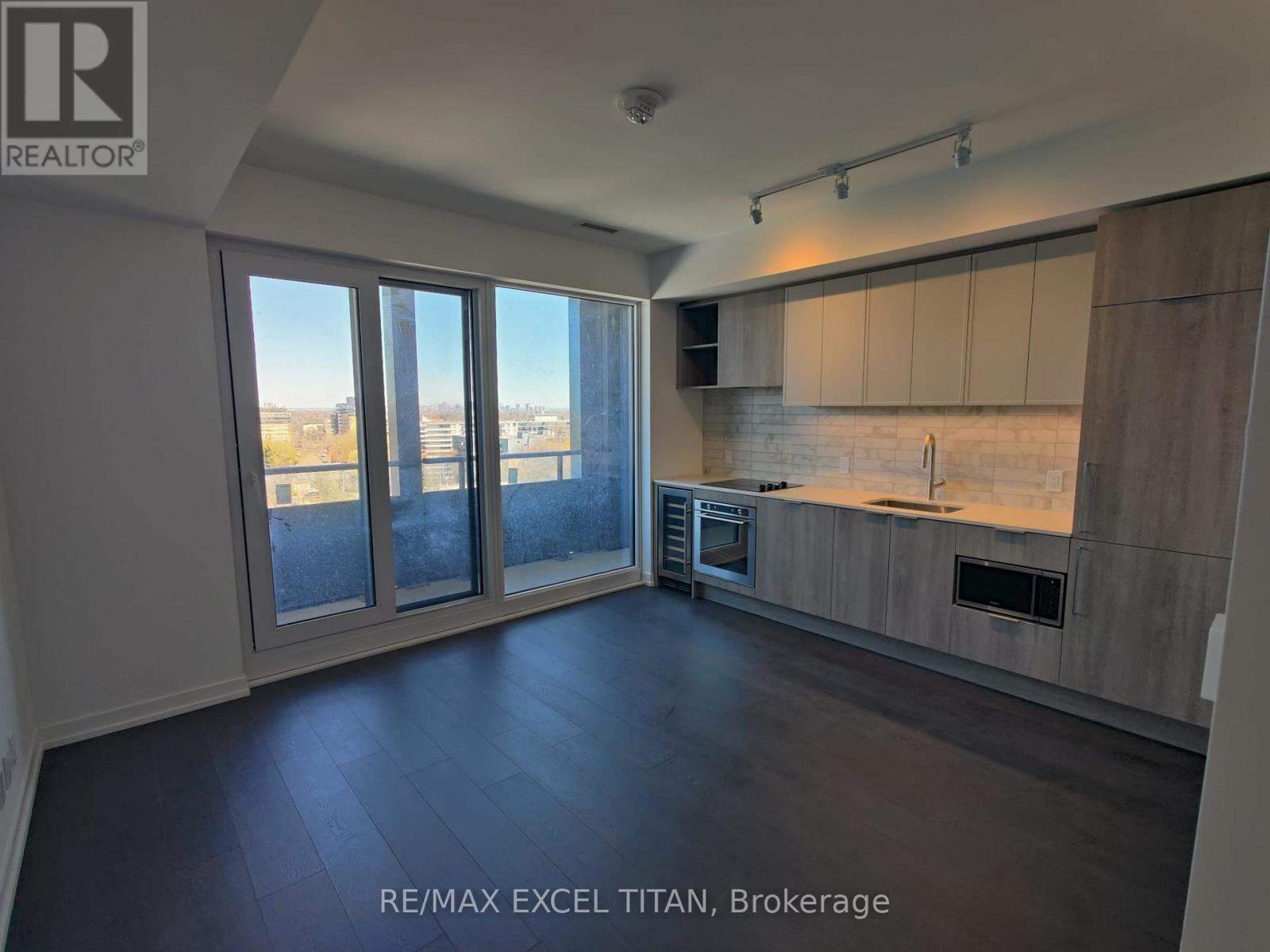 A spacious kitchen with a view of the city through large windows.