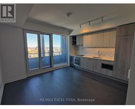 A spacious kitchen with a view of the city through large windows.