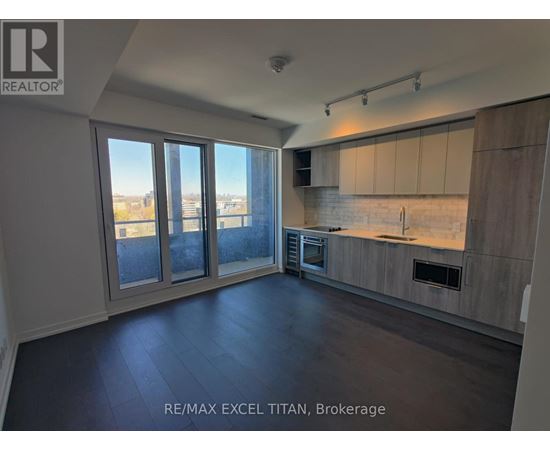 A spacious kitchen with a view of the city through large windows.