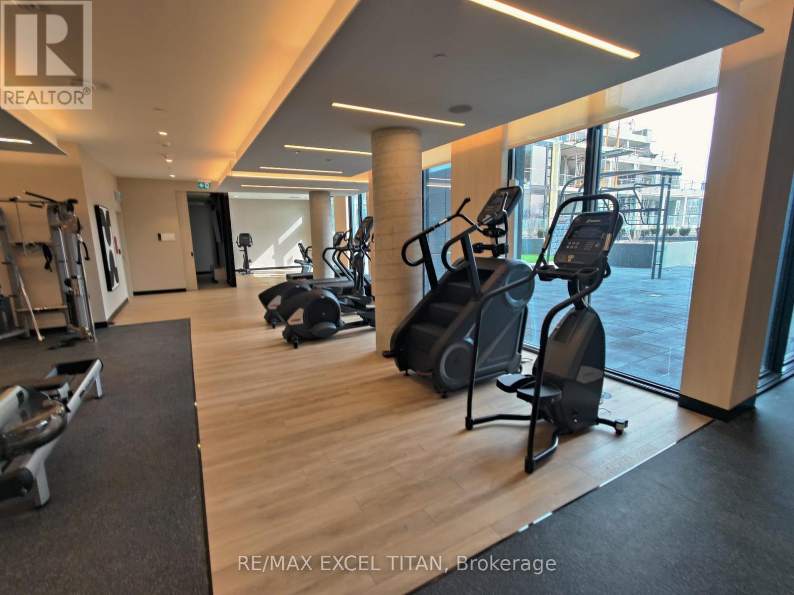 A gym with treadmills, weights, and exercise equipment.