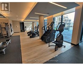 A gym with treadmills, weights, and exercise equipment.