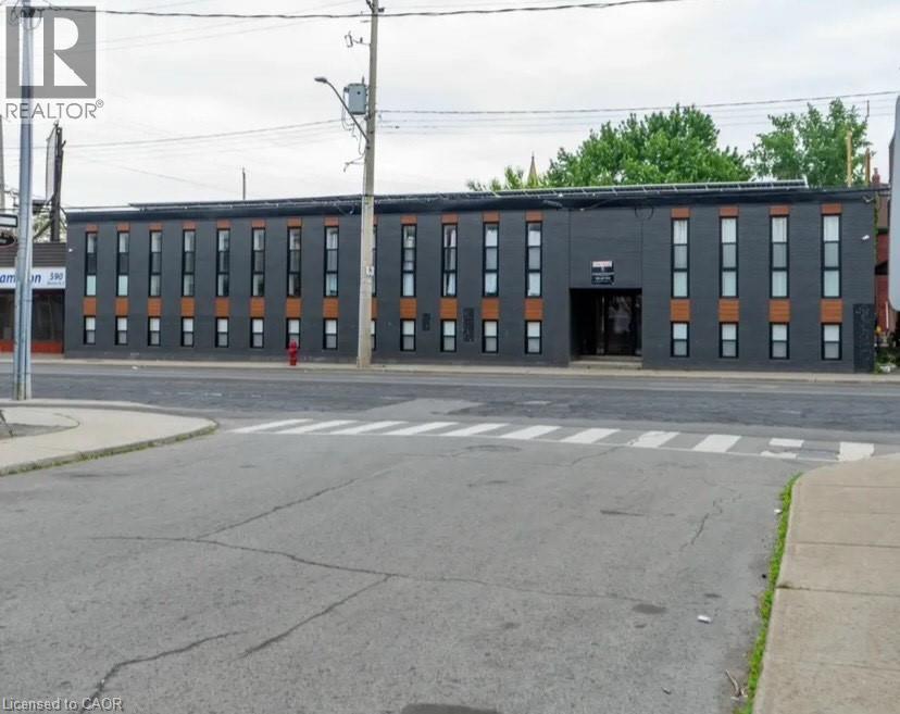 A building with a black facade and orange trim is in the image.
