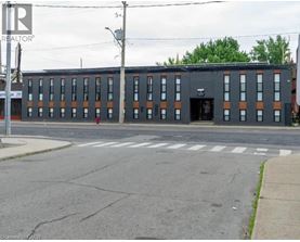 A building with a black facade and orange trim is in the image.