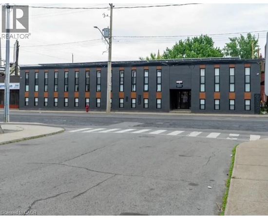 A building with a black facade and orange trim is in the image.