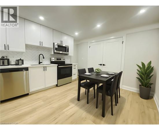 A kitchen with a table and chairs in the middle of the room.