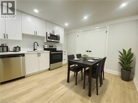 A kitchen with a table and chairs in the middle of the room.