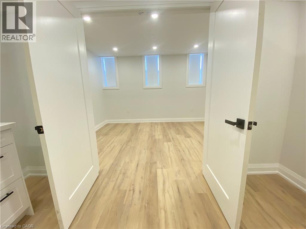 A room with wooden flooring and white walls.