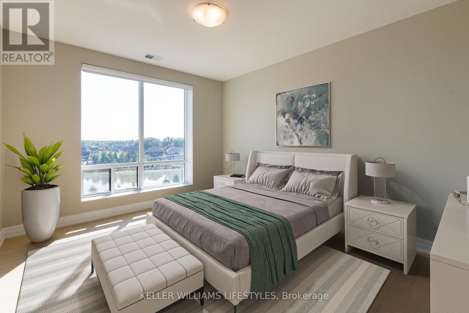 A bedroom with a large bed, a nightstand, and a window overlooking a cityscape.