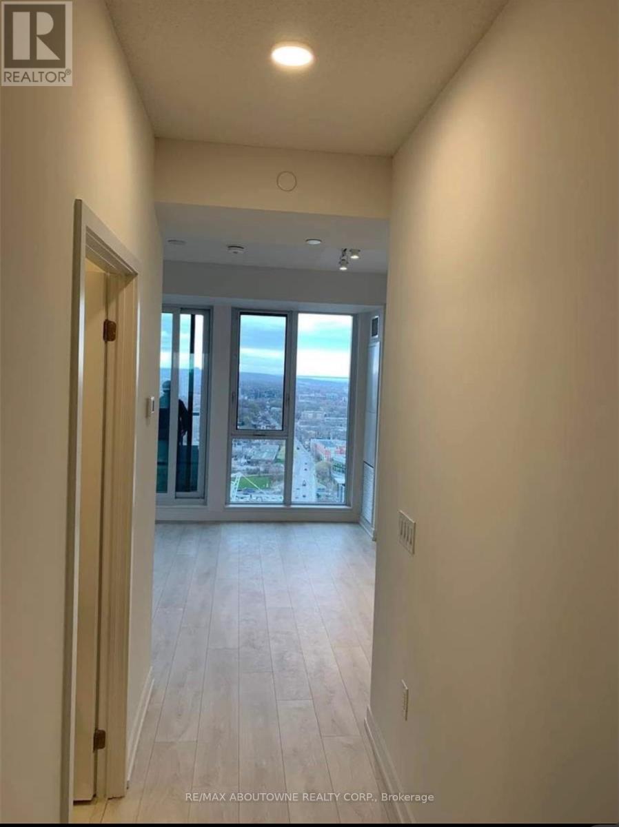 A hallway with a view of the city through the glass doors.