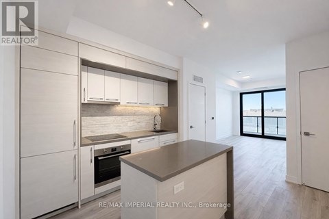 A modern kitchen with white cabinets and a large island.