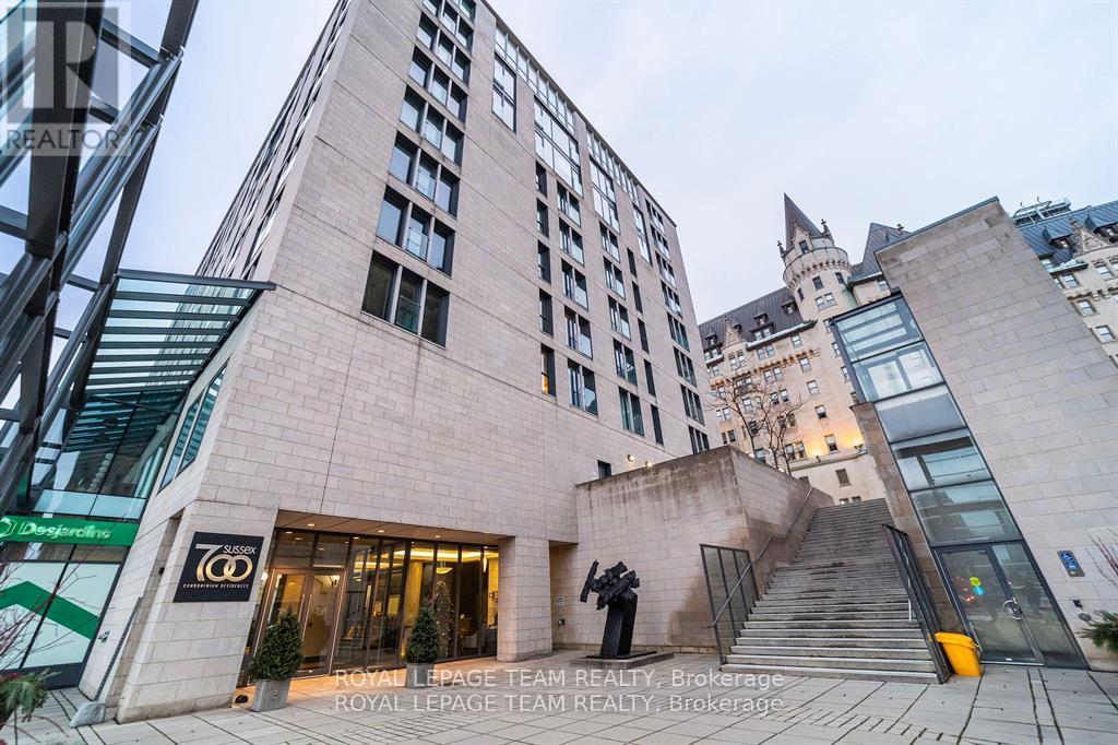 A modern building with a staircase leading to the entrance.