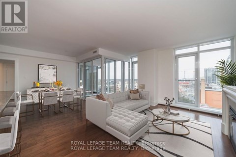 A well-lit, spacious living room with a dining table set for six.