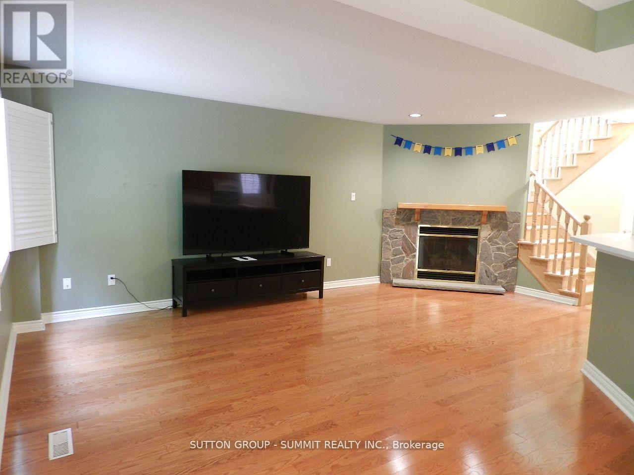 A living room with a fireplace and a television.