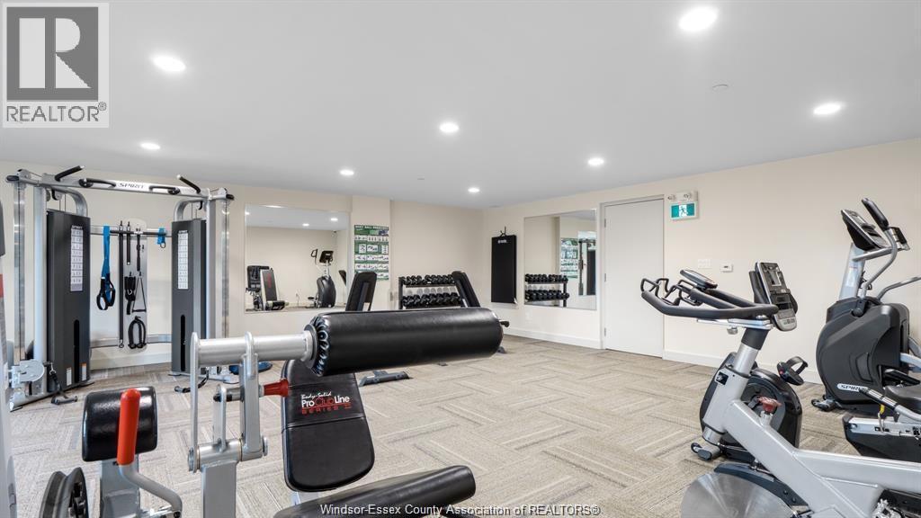 A gym with a variety of equipment including a treadmill, weights, and a stationary bike.