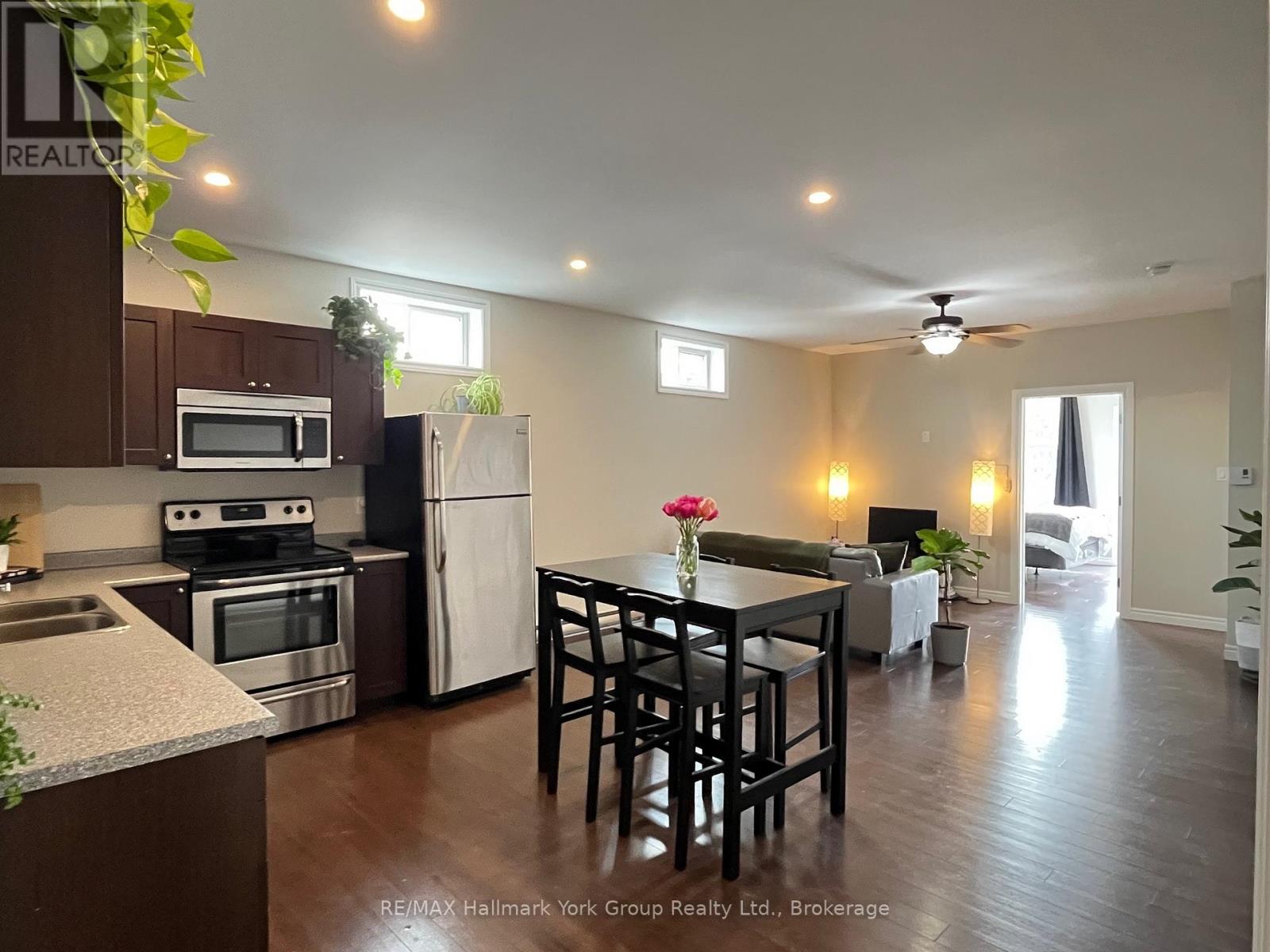 A kitchen with a table and chairs in the middle of the room.