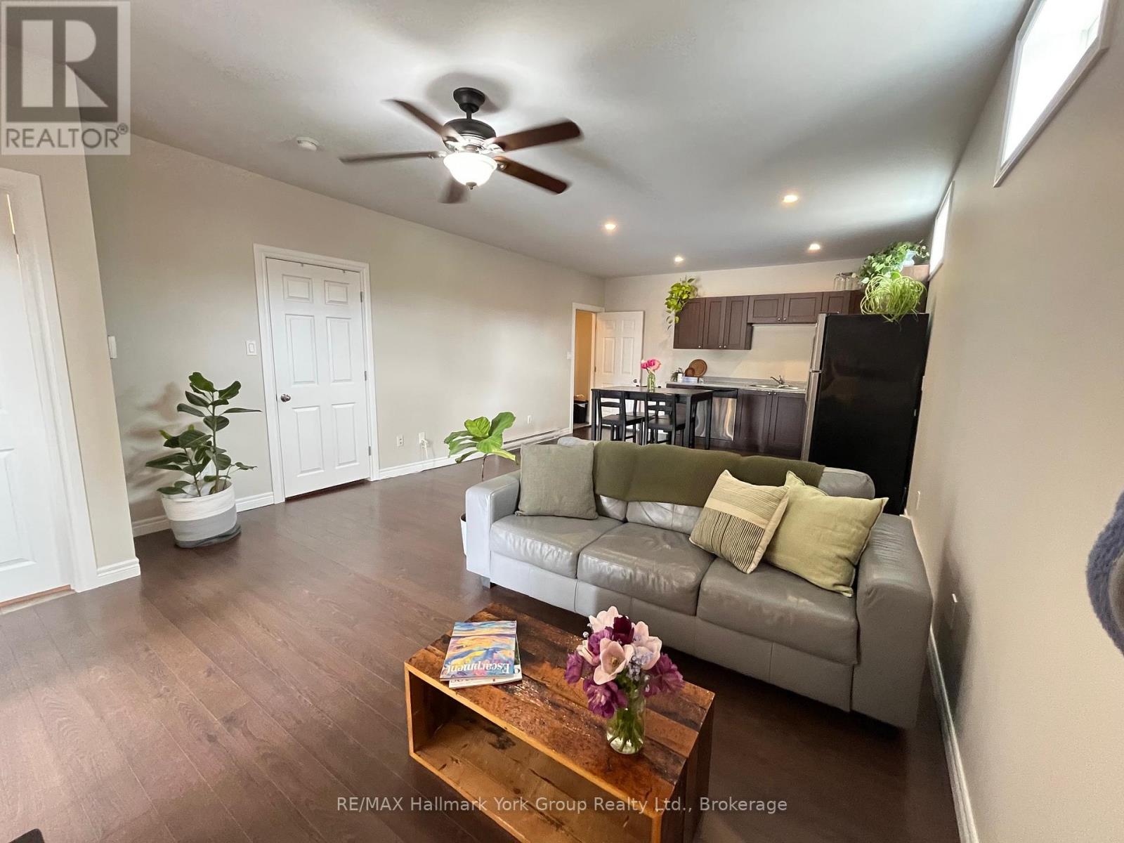 A living room with a grey couch and a wooden coffee table.