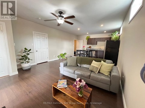 A living room with a grey couch and a wooden coffee table.