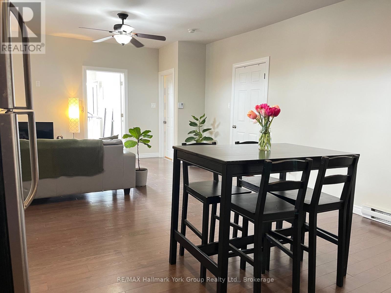 A dining room with a table and chairs.