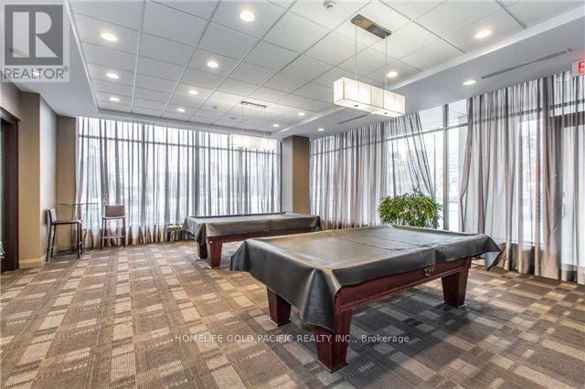 A spacious room with a massage table and a plant in the corner.