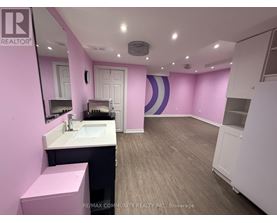 A bathroom with a sink, mirror, and toilet.