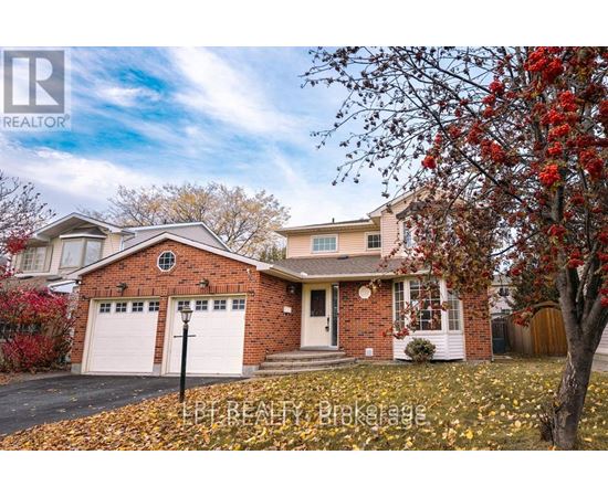 A house with a red brick exterior and a white garage door is surrounded by fallen leaves.