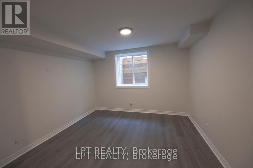 A room with a window and wooden flooring.
