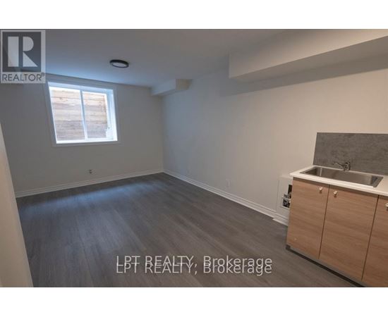 A room with a window and a sink in it.