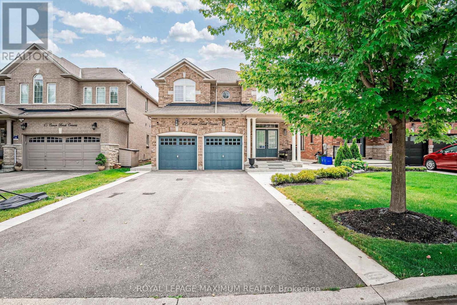 A large house with a driveway in front of it.