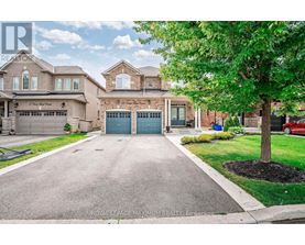 A large house with a driveway in front of it.