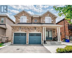 A two-story house with a brick facade and two garage doors.