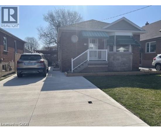 A house with a car parked in front of it.