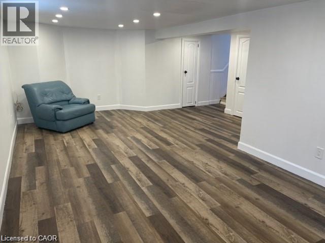 A room with wooden flooring and a blue chair.