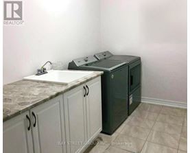 A kitchen with a sink, a dishwasher and cabinets.